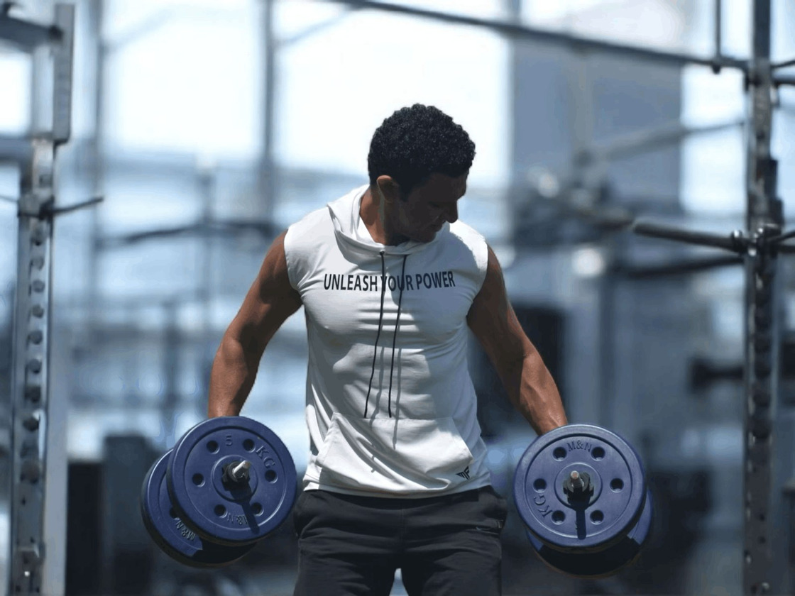 Athlete training with dumbbells in a gym